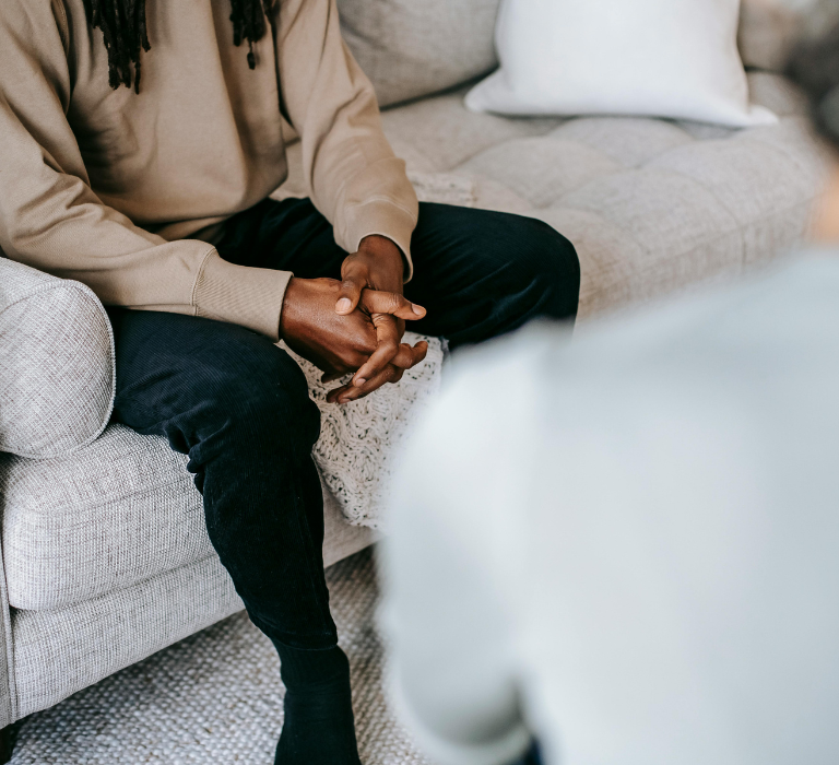 A WeCare therapist meeting with a client in a comfortable, home-like setting